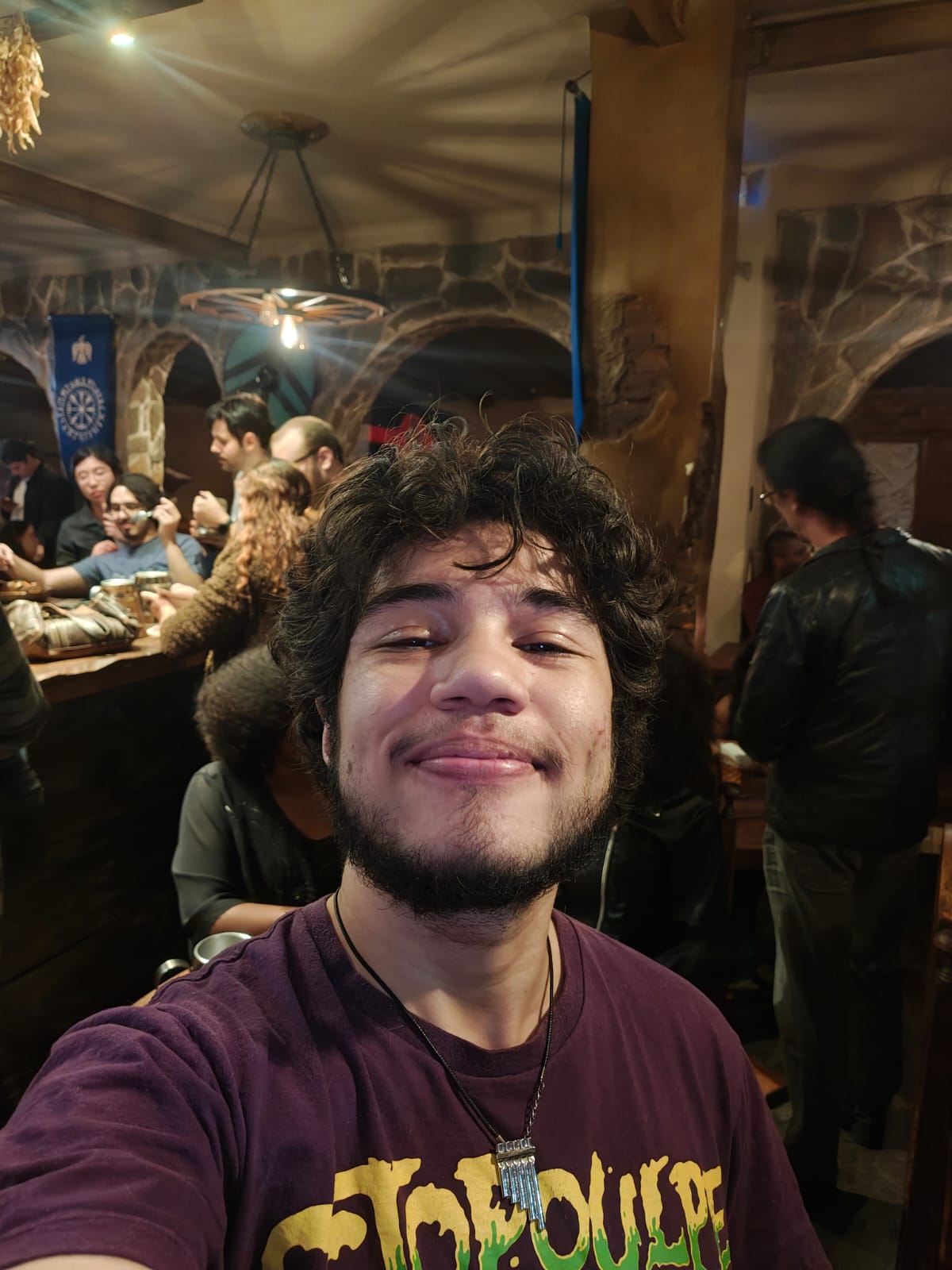 Me grinning in a crowded medieval-themed tavern
