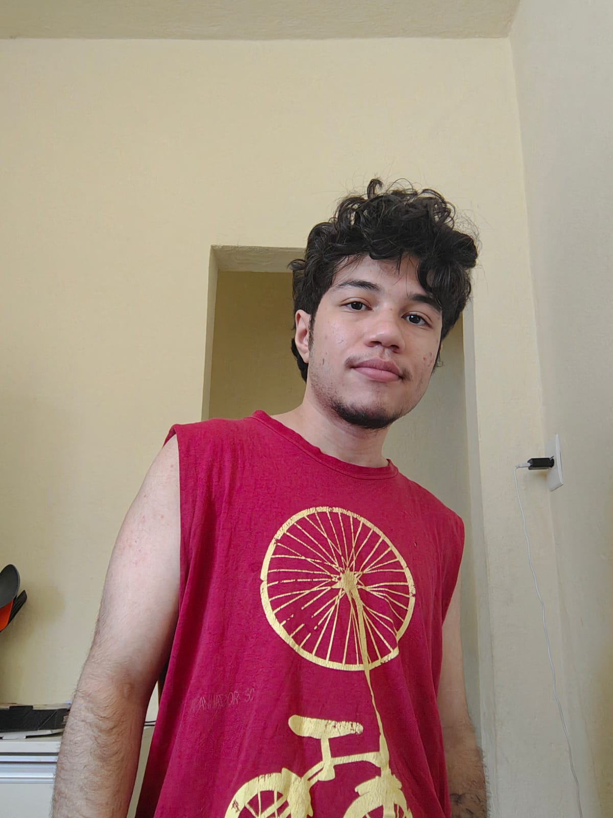 Me in a red sleeveless shirt with a bicycle print